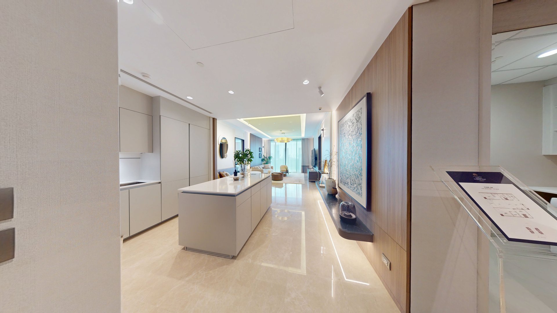 A bright kitchen opening into the living room in the featured Sindhorn Kempinski residence tour